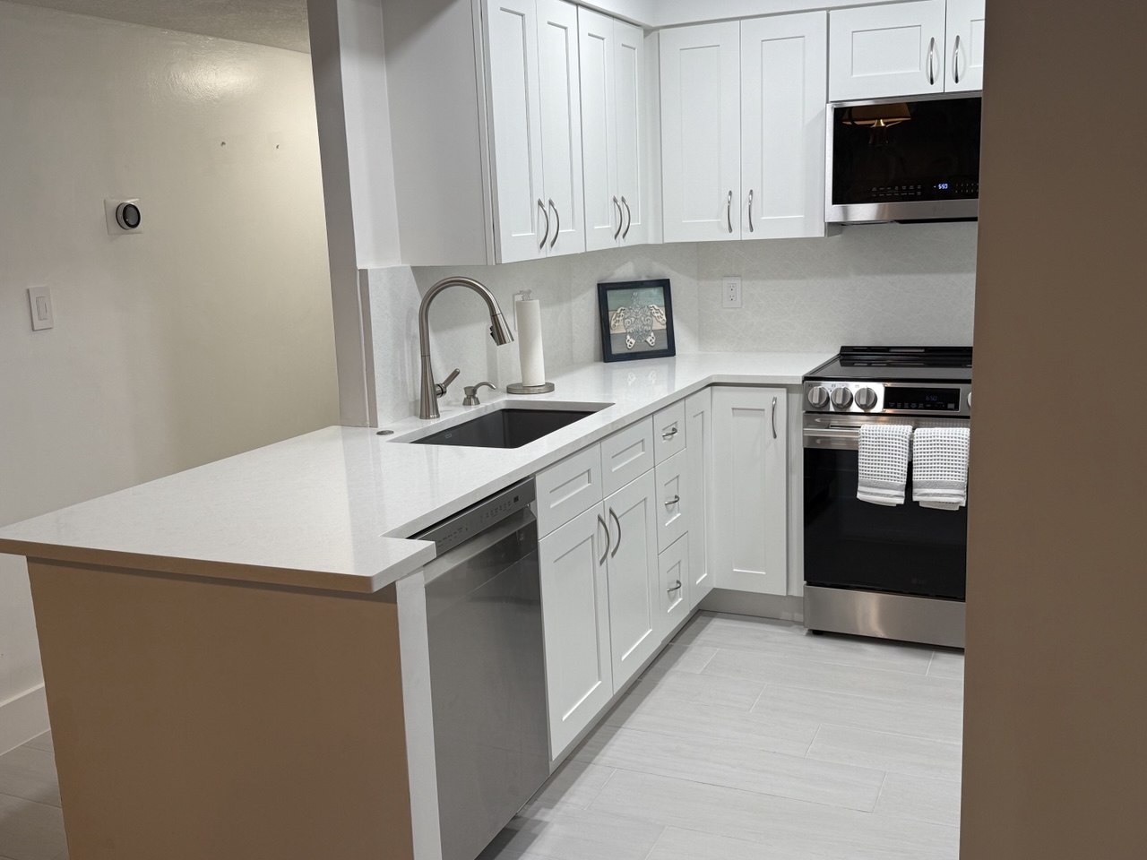 L-shaped kitchen layout with island and black undermount sink in Marco Island home