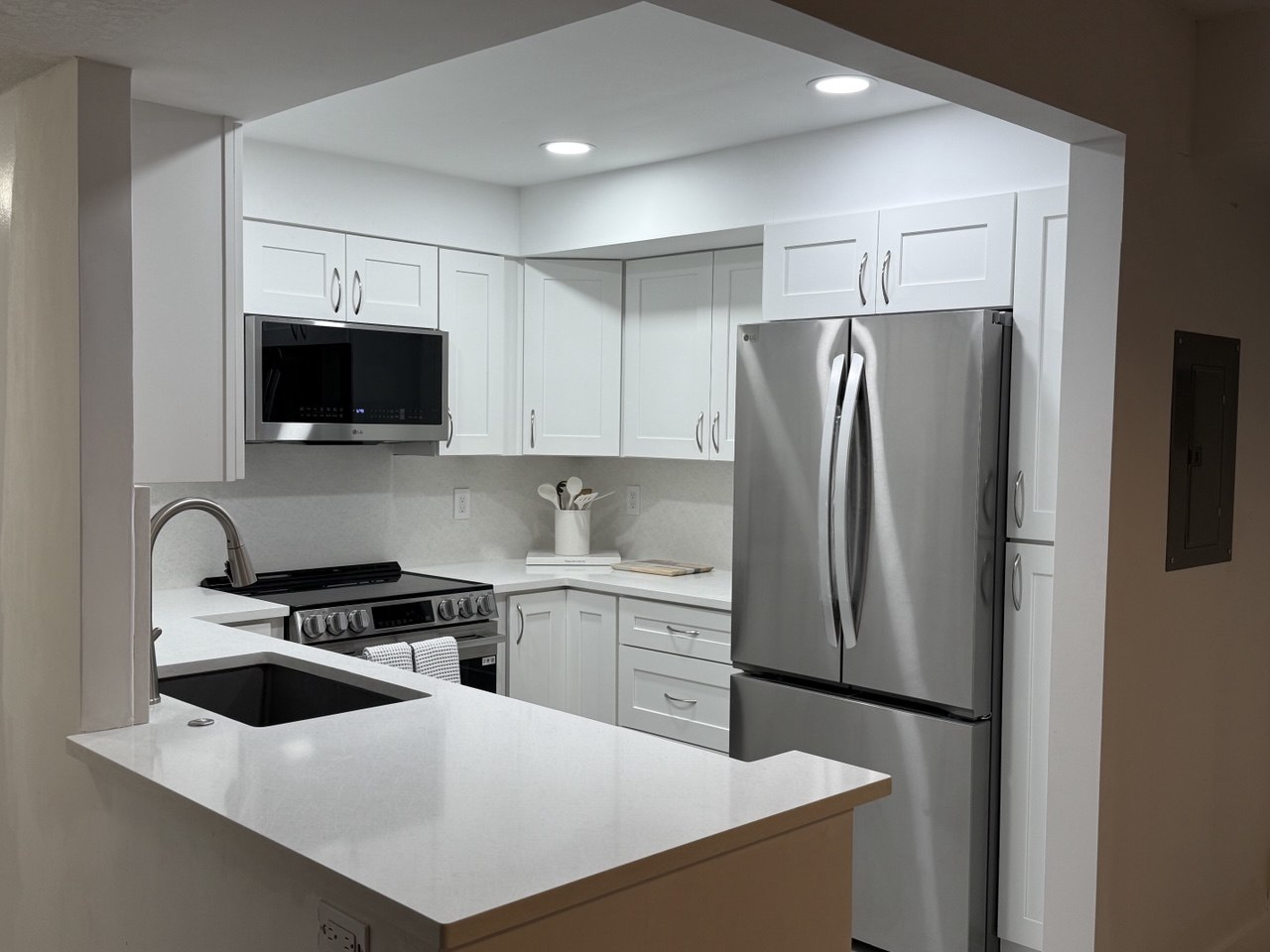 Full view of renovated kitchen from living area showing open layout in Marco Island home